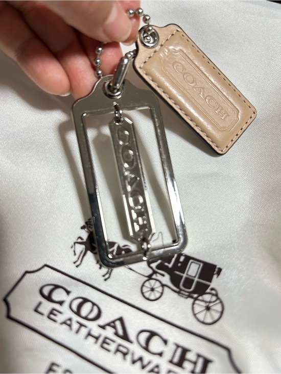 Coach Handbags - Coach Tan Leather & Silver Metal hang Tags